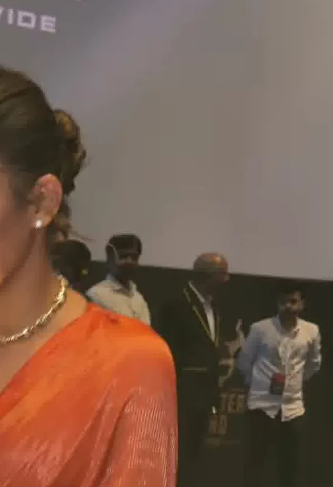 Nayanthara — Close on the drape, lit from the side — the only texture is a fine self-tone tissue-silk sheen, not a print