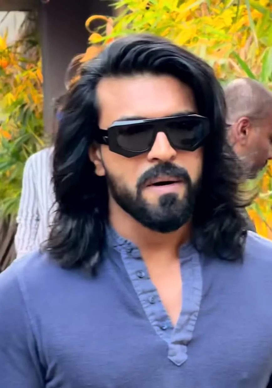The slate-blue collarless shirt — Ram Charan