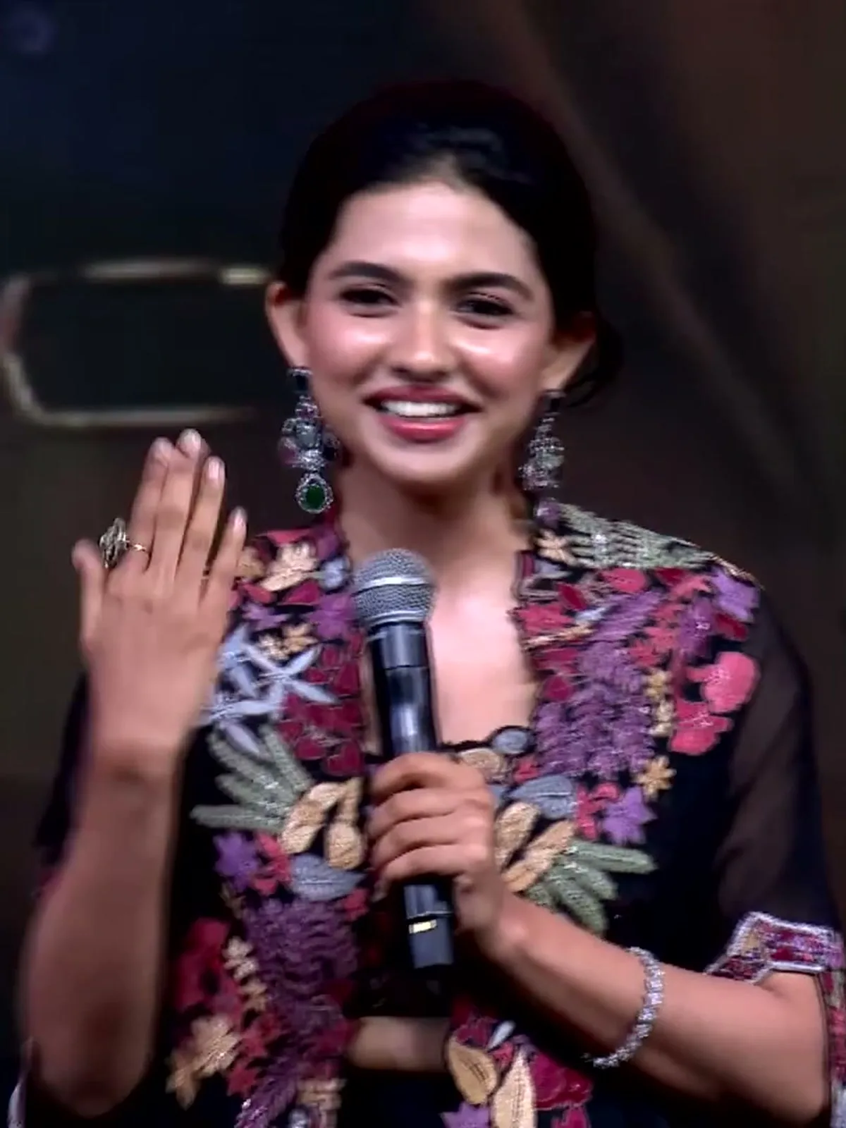 Mamitha Baiju — Close on the front: magenta, lilac, cream and sage-grey flowers outlined so they sit proud of the organza