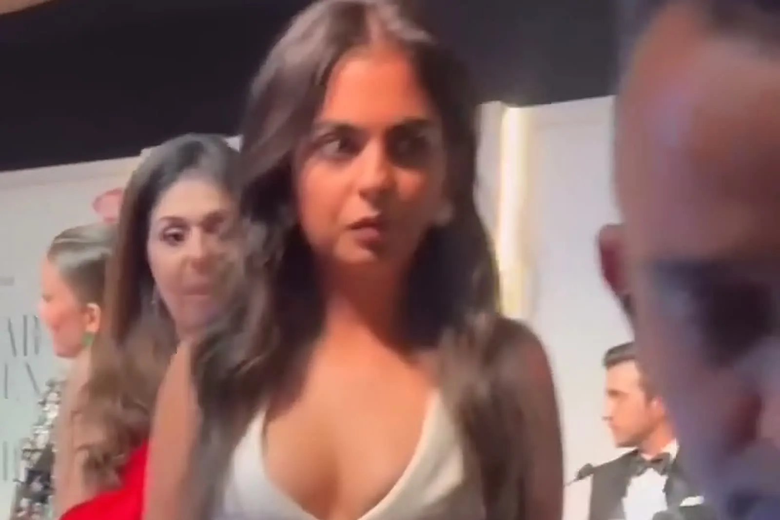 Isha Ambani — Front on: the welt pocket at the hip and the pointed centre-front hem of the gilet