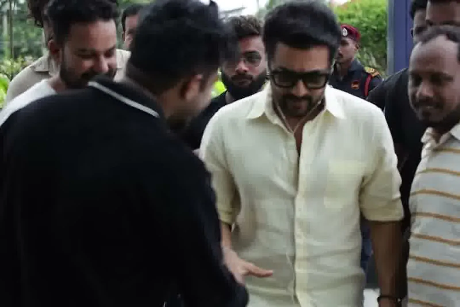 Suriya — Side on, walking through the crowd