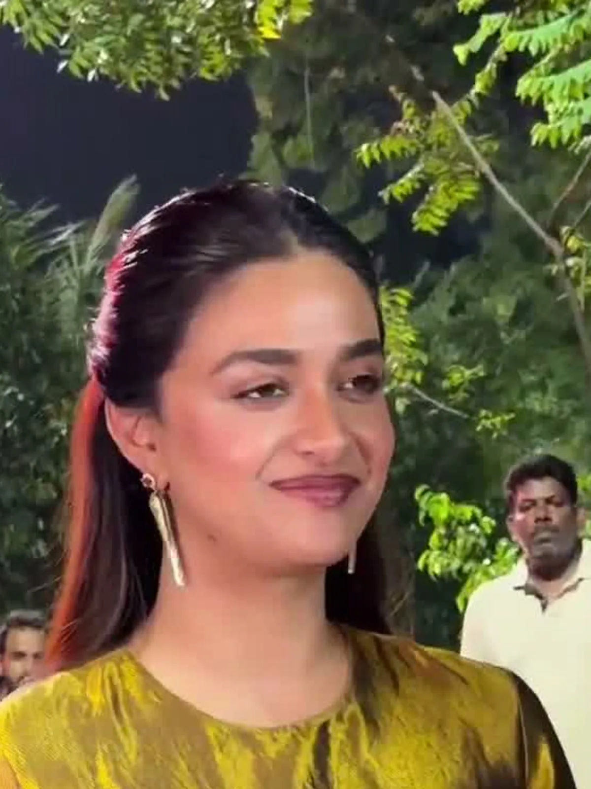 Keerthy Suresh — Arriving: the plain round neck and the long gold drop earring