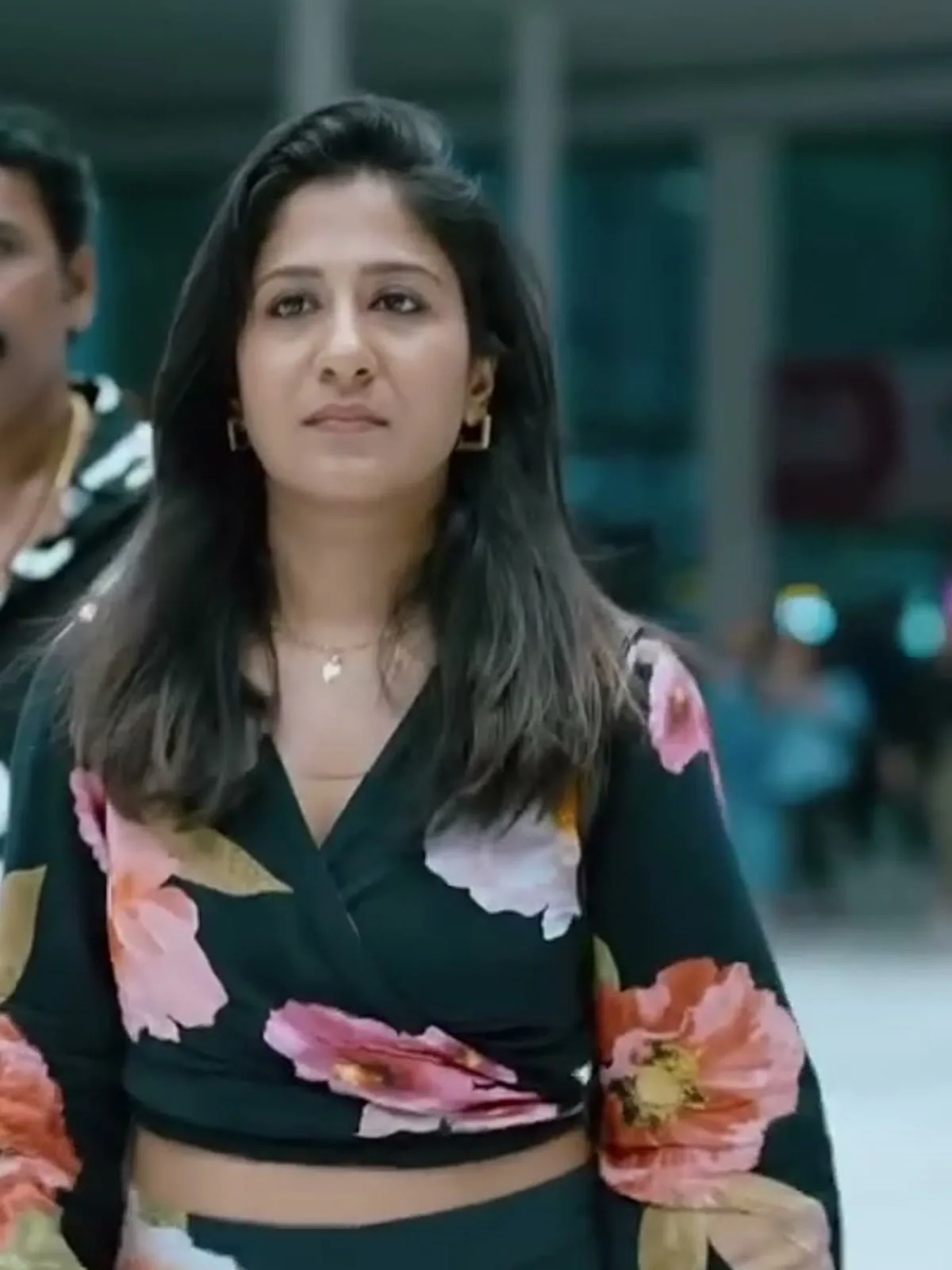 Shweta Mohan — Front on — the wrap front, the tie at the waist, and the scale of a single bloom across the chest