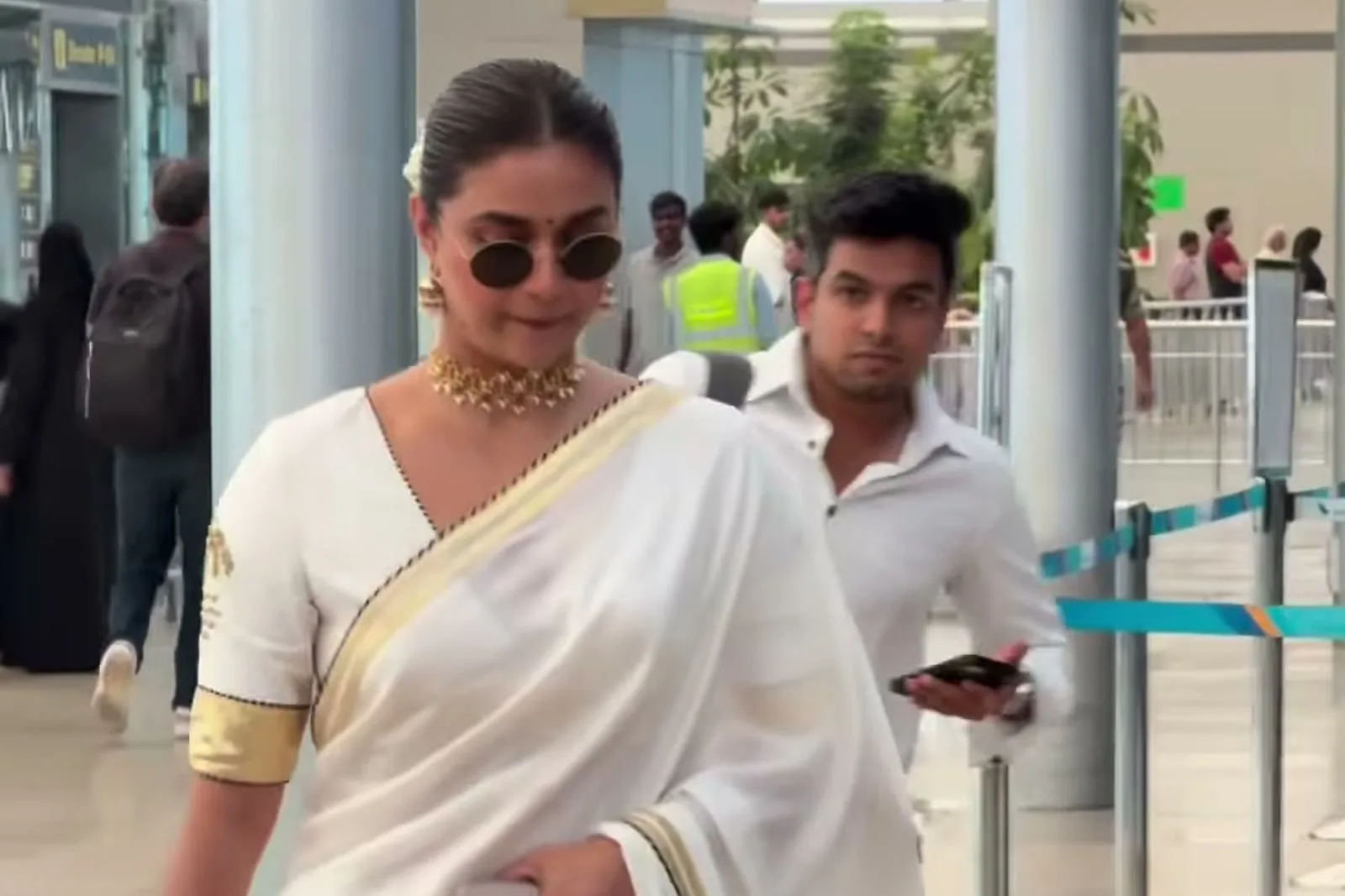 Keerthy Suresh — Walking out: the gold cuff and the palm-and-moon motif on the sleeve