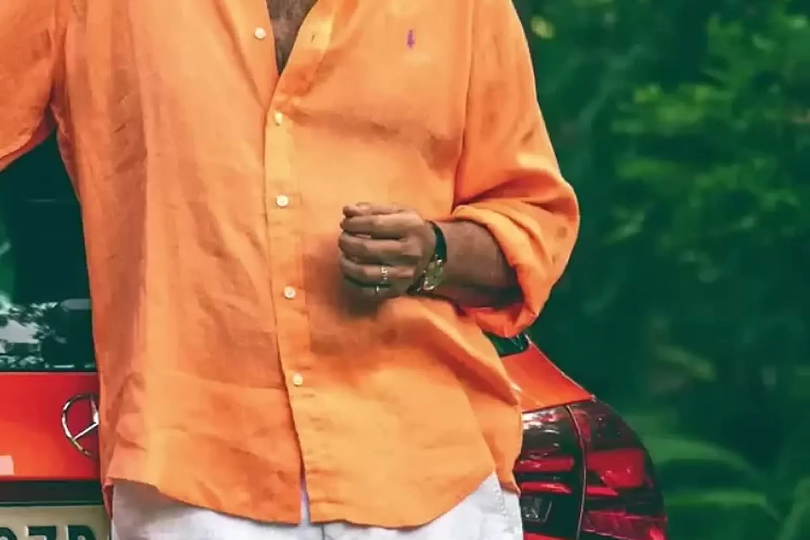 Mammootty — The sleeves rolled to just below the elbow, and the gold bracelet watch