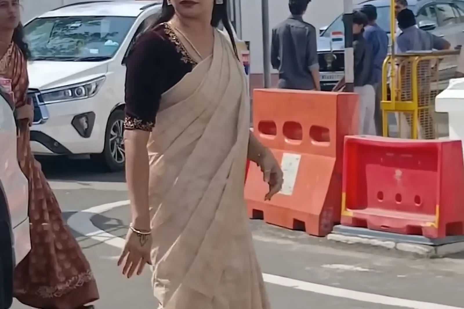 Kanimozhi Santhosh — Turning to camera: the neckline band and the bangle-and-watch wrist