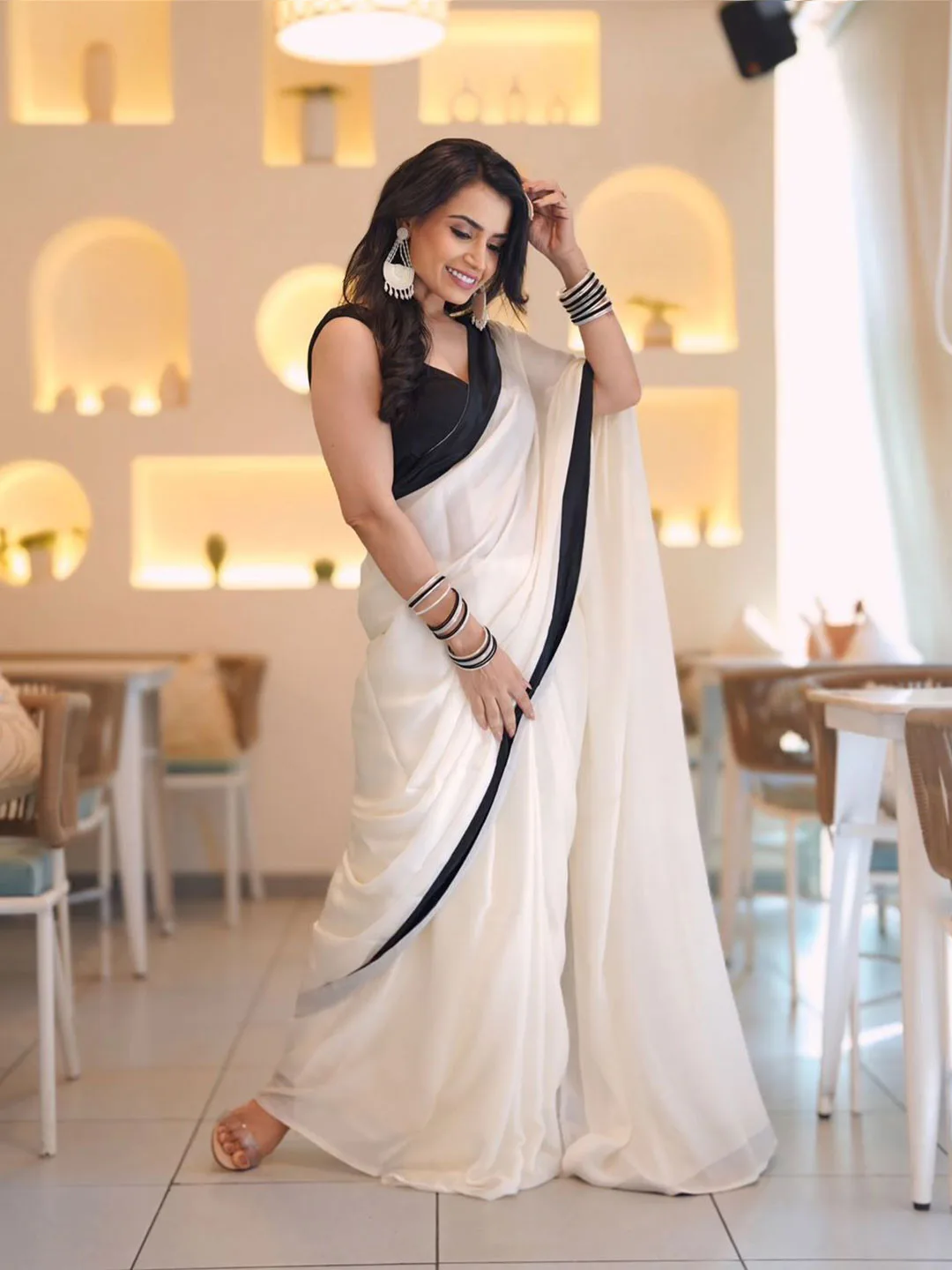 ARPITA FASHION Ivory crepe saree with a black border